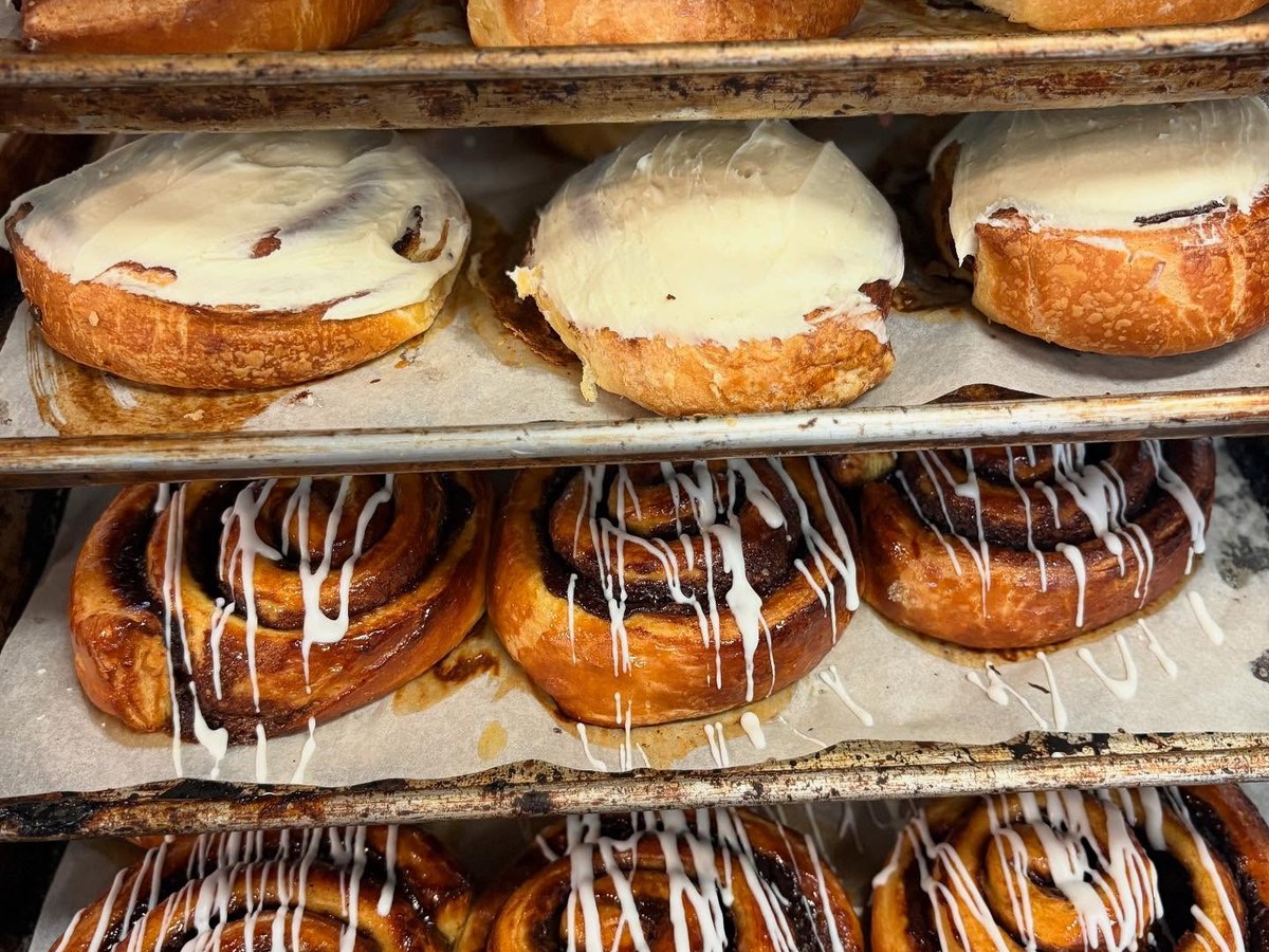 Close-up of warm cinnamon rolls with cream cheese icing